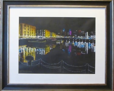 Reflections of lit-up buildings sparkle on the water of Albert Dock in Liverpool. Drawn in soft pastel on black paper. 