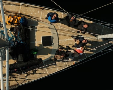 a group of people standing on a sailing boat in Tromsø | ski and sail in Norway