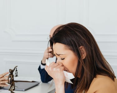 a woman sitting at a table with a man in a suit and tie