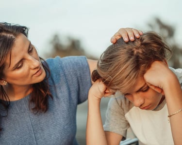a woman is sitting at a table with a child