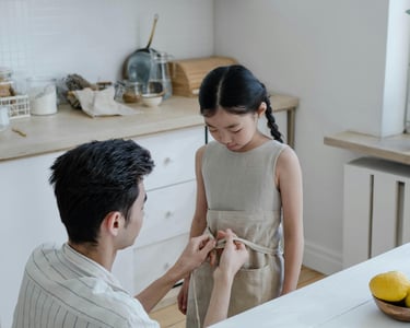 a man and woman standing in a kitchen