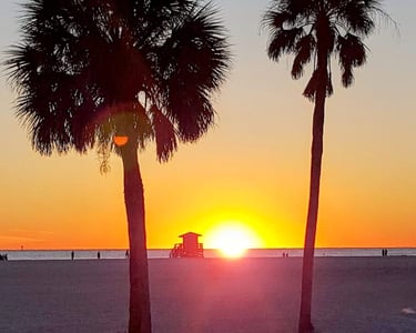sunset on Siesta Beach at the yellow lifeguard tower