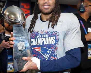 Stephon Gilmore holding the Lombardi Trophy following the Patriots victory of the Rams in Super Bowl LIII