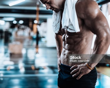 a man standing in the gym after training