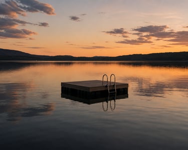 Floating dock on a calm lake at sunset.