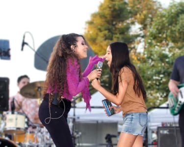 Lady Ivy singing with fan