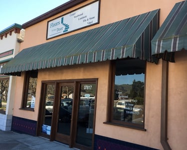 a building with a green awning and a sign that says,
