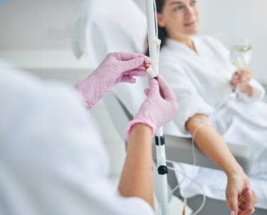 nurse giving an iv drip of vitamin to a woman