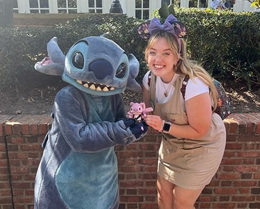 Ameliah Knopp pictured with Stitch at EPCOT®.