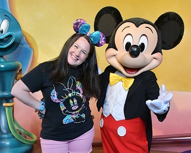 Kristen Breedlove pictured with Mickey Mouse at Disneyland® Park.
