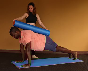 a man and woman doing pilates exercises on a mat
