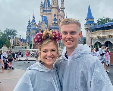 Kasey Kalk pictured with her husband in front of Cinderella Castle at Disney's Magic Kingdom®.