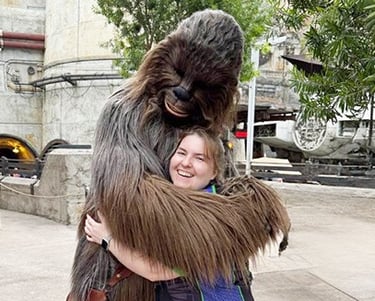 Sarah Brewer pictured with Chewbacca inside Galaxy's Edge inside Disney's Hollywood Studios® Park.