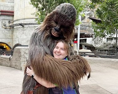 Sarah Brewer pictured with Chewbacca inside Galaxy's Edge inside Disney's Hollywood Studios® Park.