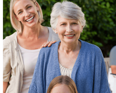a young girl, a woman and her mother (grandmother) standing in front of a table