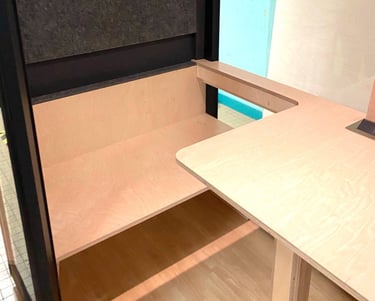 a desk with a laptop and a laptop on it