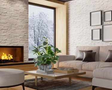 Modern living room featuring a cozy fireplace, white brick walls, and a green houseplant overlooking a snowy winter scene.