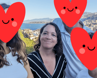 a group of people standing around a group of red hearts