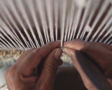 Artisan handknotting a rug in Bhadohi, India