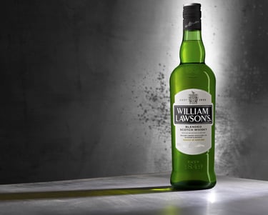 Green William Lawson's Whisky bottle on a metal background with long shadow