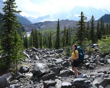 a woman with a backpack on a rocky trail