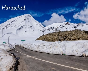 a road with snow on the side of a mountain