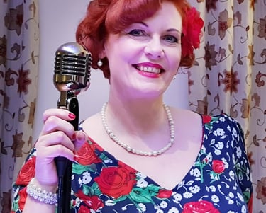 Lady stood holding a vintage style microphone