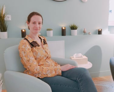 a woman sitting in a chair with a clock on the wall