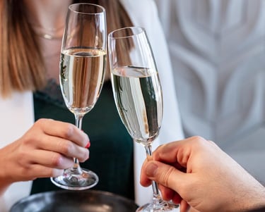 a man and woman holding glasses of champagne