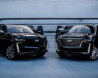 a black cadillac suv with a black car parked in a parking lot