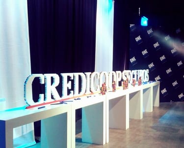 a man standing in front of a sign that says creditocoop seguros rasti corporasti