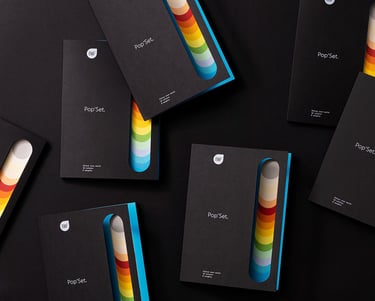 product photography - a group of four different coloured booklets