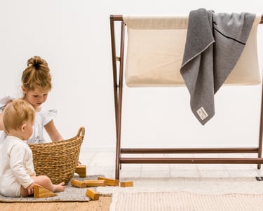 Product photography - a baby girl and boy playing with a basket and blocks