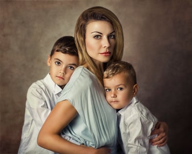a mother embracing her two young boys in a family photo session