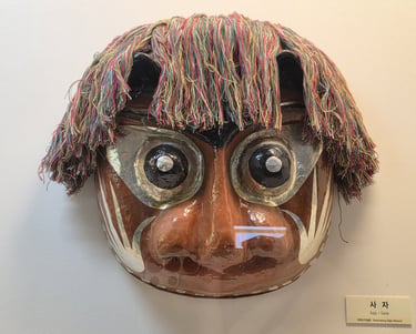 Bukcheong Saja Noreum lion mask on display at the Hahoe World Mask Museum