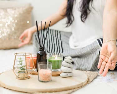 a woman sitting on a bed with candles and candles