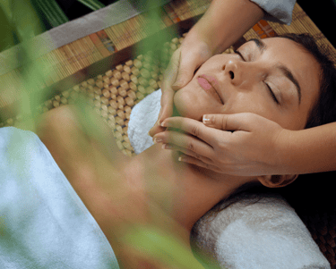 a woman getting a facial massage at a spa