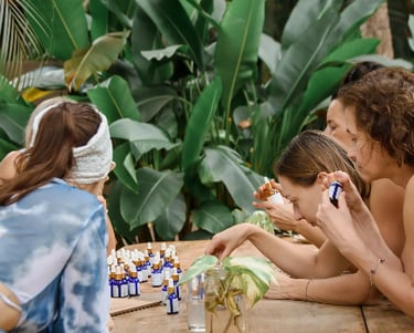 a group of people sitting around a table of aromaoils