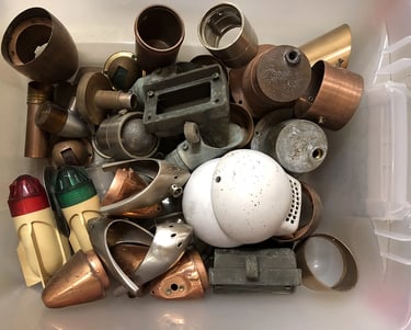 Various parts in a sculptor's workshop bin.