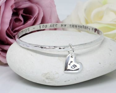 Handcrafted silver jewellery personalised with an age and message for milestone birthdays