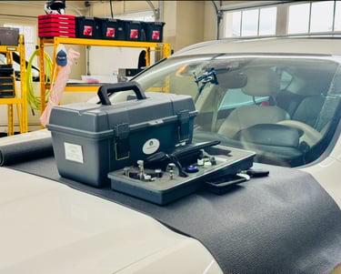 One of our indoor customer call-out reapirs. Inside a garage with our kit on the hood of a white car
