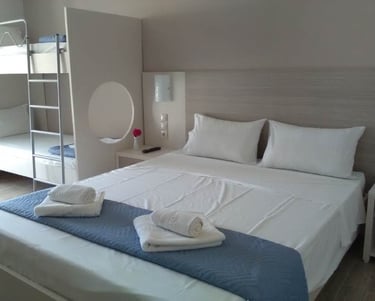 a room with a double bed and bunk beds