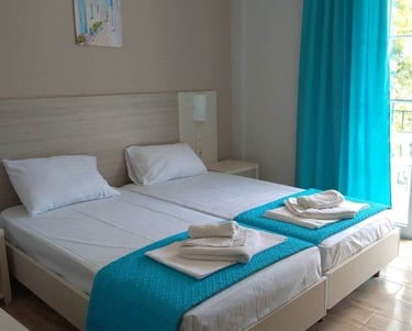 a bedroom with two beds and a balcony