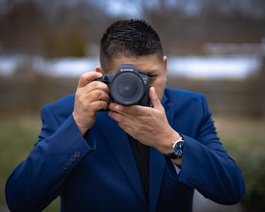a man in a suit and a watch on his camera