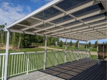 Patio Cover with railing and tinted, see-through panels.