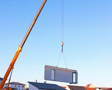 a crane is lifting a house into the air