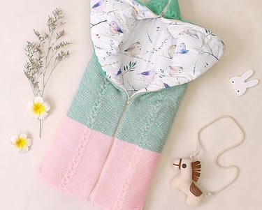 Knitted shell baby sleeping bag with cotton liner. Zipper access to open and convert to a baby blanket.