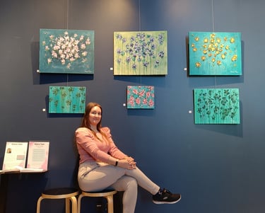 photo of the artist saara tani at her exhibition "divine garden" in september 2022
