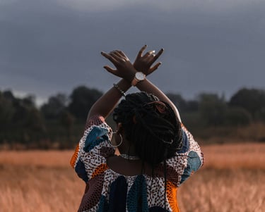 African Village Vendors Association at Leimert Park image of a black woman crossing arms in the air