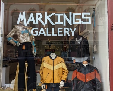 A photo of a front window of Markings Gallery